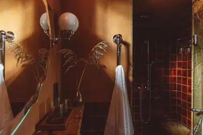 a bathroom with a shower with a towel and a sink at De Durgerdam, Amsterdam in Amsterdam