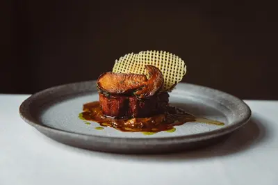 a piece of meat on a plate with sauce at De Durgerdam, Amsterdam in Amsterdam