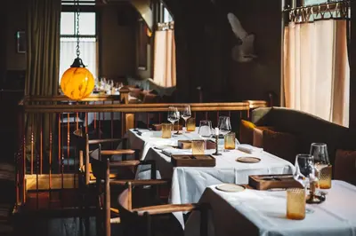a restaurant with tables and chairs with white table cloth at De Durgerdam, Amsterdam in Amsterdam