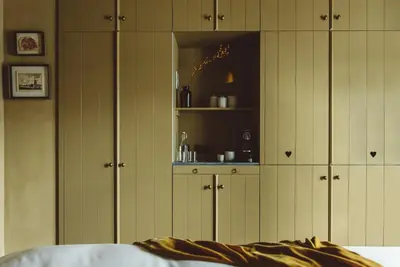 a bedroom with green cabinets and a bed at De Durgerdam, Amsterdam in Amsterdam