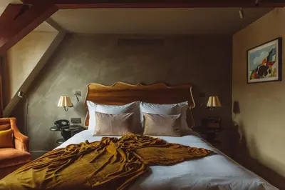 a bedroom with a large bed with a blanket on it at De Durgerdam, Amsterdam in Amsterdam