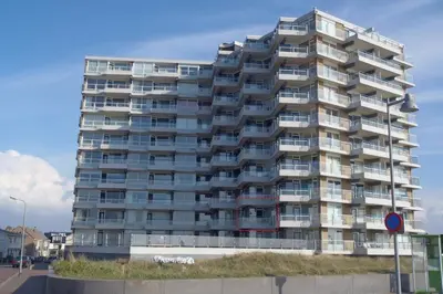 a large apartment building with balconies on a street at Sterflat 67 in Egmond aan Zee