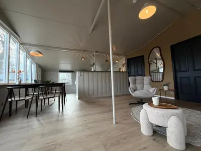 a large living room with a table and chairs at Beautiful house on an island near Amsterdam in Oude Meer