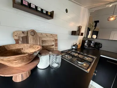 a kitchen with a wooden sink and a stove at Beautiful house on an island near Amsterdam in Oude Meer