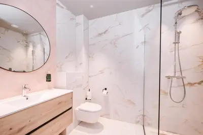 a bathroom with a shower and a toilet and a sink at Hotel Keur in Zandvoort