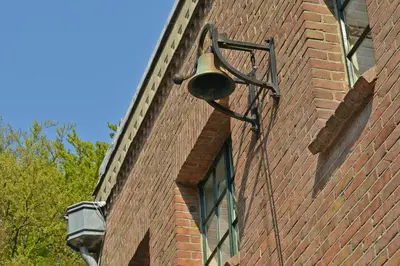 a street light on the side of a brick building at Londons Cottage in Hilversum