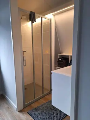 a bathroom with a shower with a glass door at Have a nice stay! - De Pottenbakkerij in Noordwijk