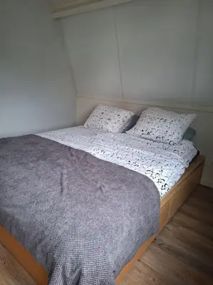 a bed with two pillows on it in a bedroom at Have a nice stay! - De Pottenbakkerij in Noordwijk