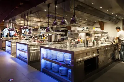 a restaurant kitchen with a chef preparing food at Van Rossum Stadshotel Woerden in Woerden