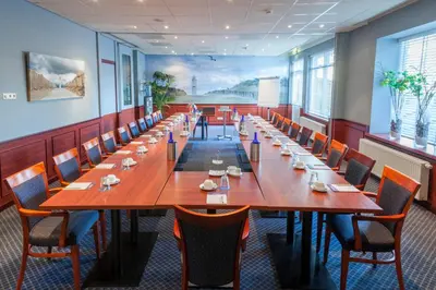 a large conference room with a long table and chairs at Two Brothers Hotel Astoria in Noordwijk aan Zee