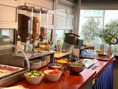 a kitchen with a counter with some food on it at Two Brothers Hotel Astoria in Noordwijk aan Zee
