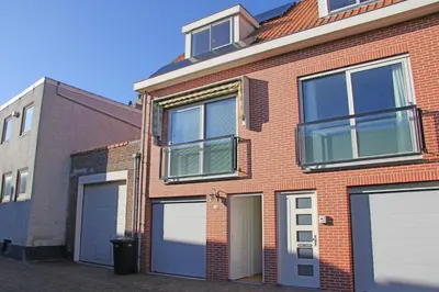 a brick building with four garage doors on it at Seapearl in Zandvoort