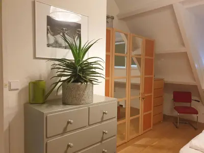 a plant on top of a dresser in a bedroom at Seapearl in Zandvoort