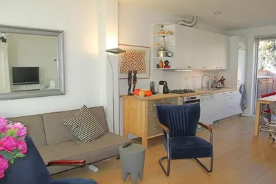 a living room with a couch and a kitchen at Seapearl in Zandvoort