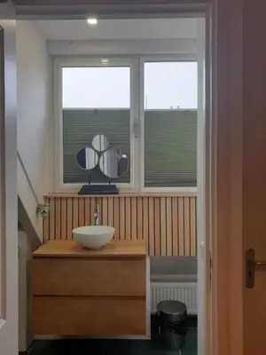 a bathroom with a sink and two windows at Seapearl in Zandvoort