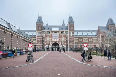 a large brick building with people on bikes in front of it at CanalView Luxury Apartment in Amsterdam
