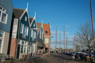 a row of houses on a street next to a marina at Apartments Waterland in Monnickendam