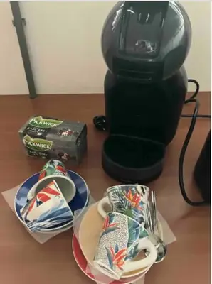 a coffee maker sitting on top of a table with plates at Charming Rooms with free parking in Amsterdam