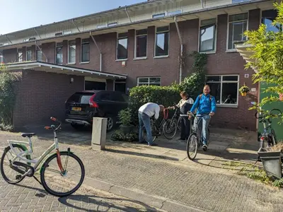 a group of people on bikes outside of a building at Charming Rooms with free parking in Amsterdam