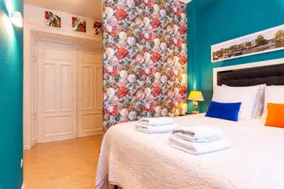 a bedroom with a bed with a floral wall at B&B Blossom in Amsterdam