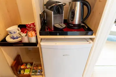 a refrigerator with a coffee maker on top of it at B&B Blossom in Amsterdam