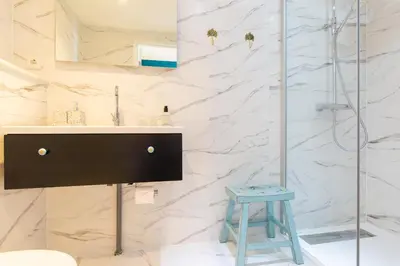 a bathroom with a sink and a glass shower at B&B Blossom in Amsterdam