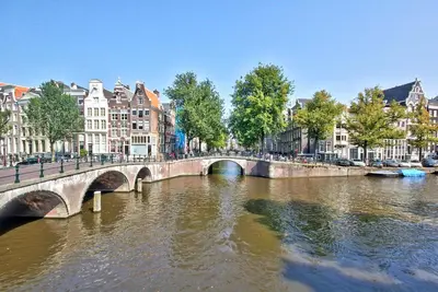 a bridge over a river in a city with buildings at B&B Blossom in Amsterdam