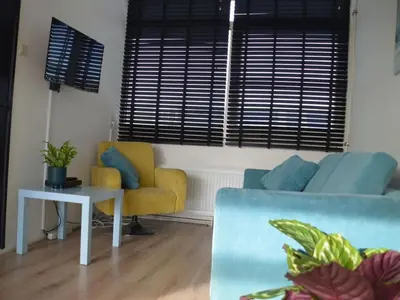 a living room with a couch and a table at Holiday apartment Seapaerdje in Bergen aan Zee