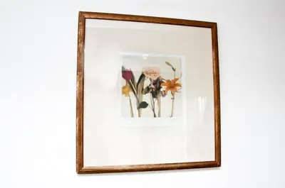 a framed picture of flowers on a wall at Budget Hotel Ben in Amsterdam