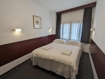 a bedroom with a bed with two pillows on it at Budget Hotel Ben in Amsterdam