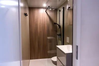 a bathroom with a shower with a toilet and a sink at Luxurious waterloft near beach and centre by Weltevreden Experience in Zeewolde