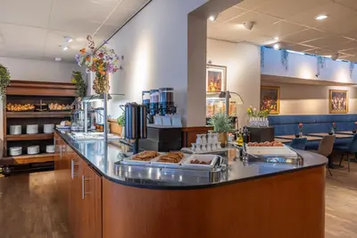 a bakery with a counter with pastries on it at Amrâth Grand Hotel Frans Hals in Haarlem
