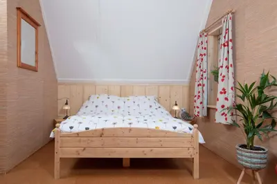 a bedroom with a bed in a room at Vegan B&B De Groene Mus in Wervershoof