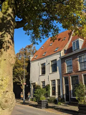 a large white house with a red roof at Het Pakhuis Haarlem in Haarlem