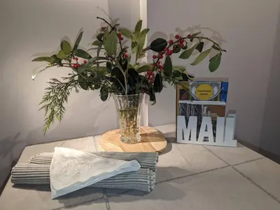 a vase of flowers sitting on a table with towels at Het Pakhuis Haarlem in Haarlem