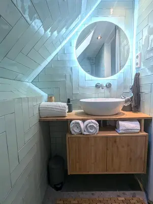 a bathroom with a sink and a mirror at Het Pakhuis Haarlem in Haarlem