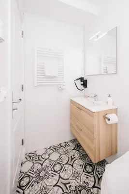 a bathroom with a sink and a mirror and a shower at Simply studio's in Zandvoort