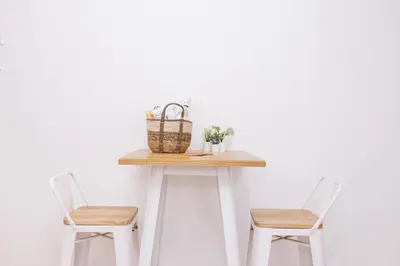 a table with two chairs and a basket on it at Simply studio's in Zandvoort