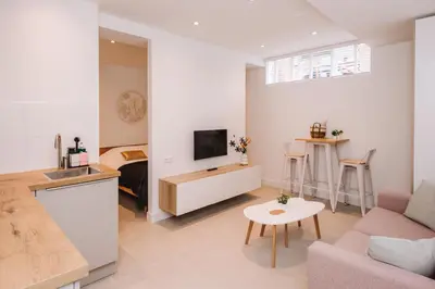 a living room with a couch and a tv at Simply studio's in Zandvoort