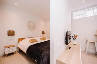 a bedroom with a bed and a table in it at Simply studio's in Zandvoort