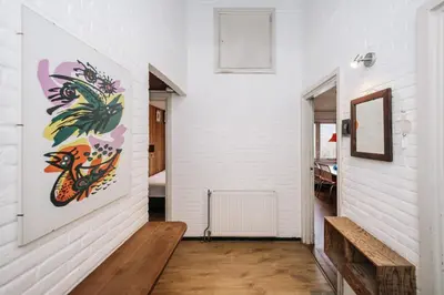 a hallway with a painting of a chicken on the wall at Villa Zuidwest 6, Garden, Dunes & Free parking in Zandvoort