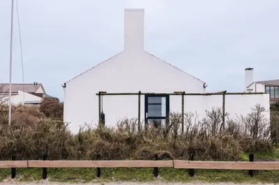 a church with a wooden fence in front of it at Villa Zuidwest 6, Garden, Dunes & Free parking in Zandvoort