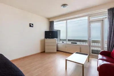 a living room with a couch and a tv at Seaside in Zandvoort