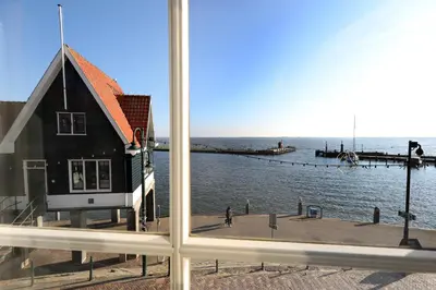 a view of a pier from a window at Hotel Cafe Restaurant Van Den Hogen in Volendam