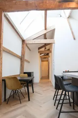 a room with tables and chairs and a ceiling at The Prinsen in Amsterdam