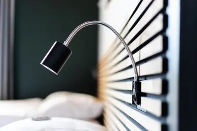a lamp sitting on a bed next to a window at Weber Hotel in Amsterdam