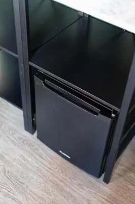a black tv sitting on top of a wooden floor at Weber Hotel in Amsterdam