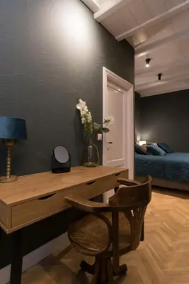 a room with a desk with a vase of flowers at B&B Felix in Amsterdam
