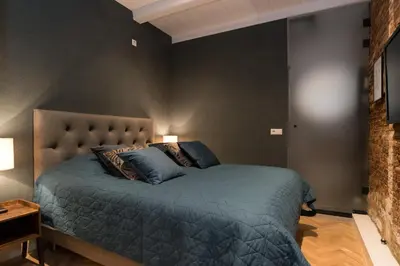 a bedroom with a bed with a blue comforter at B&B Felix in Amsterdam