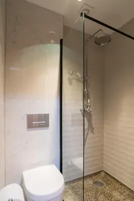 a bathroom with a toilet and a glass shower at B&B Felix in Amsterdam